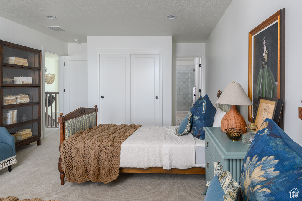 Bedroom featuring carpet, a closet, and visible vents