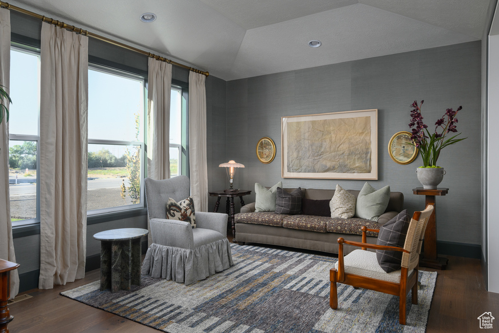 Living area with baseboards and wood finished floors