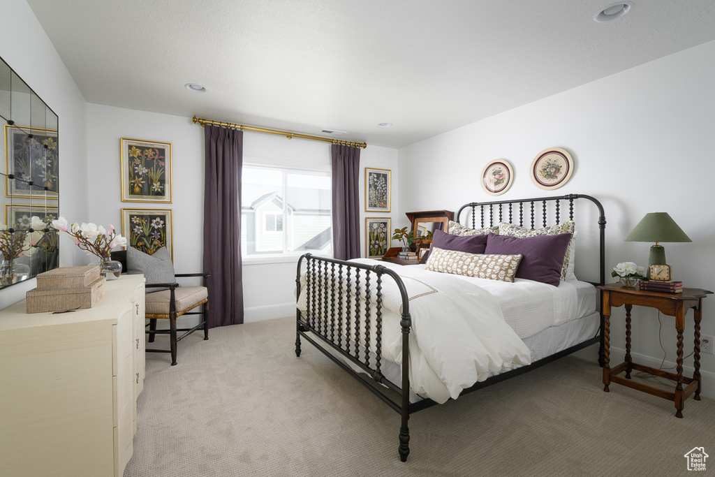 Bedroom featuring baseboards, recessed lighting, and light carpet