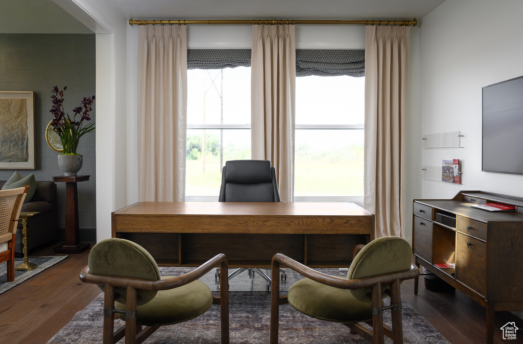Home office with dark wood-style flooring
