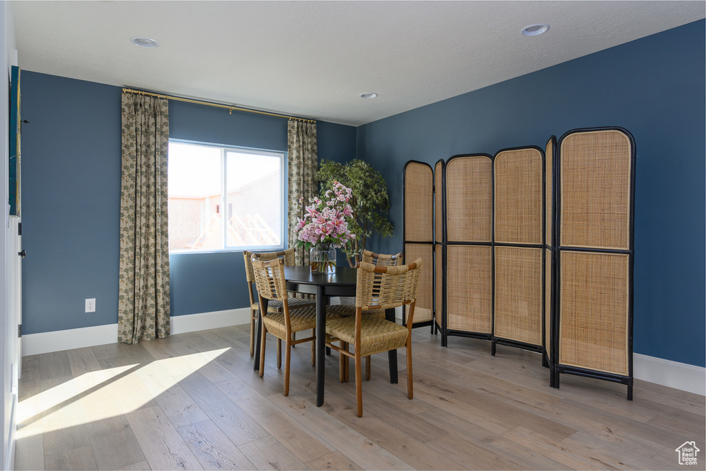 Dining area featuring recessed lighting, baseboards, and wood finished floors
