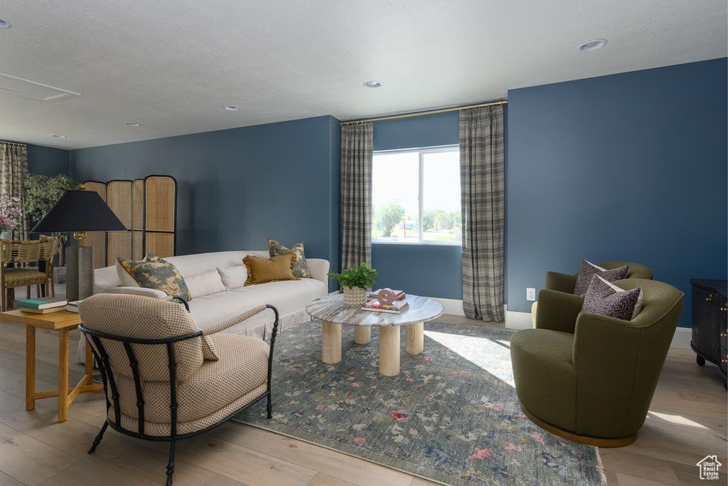 Living area with recessed lighting, wood finished floors, and attic access