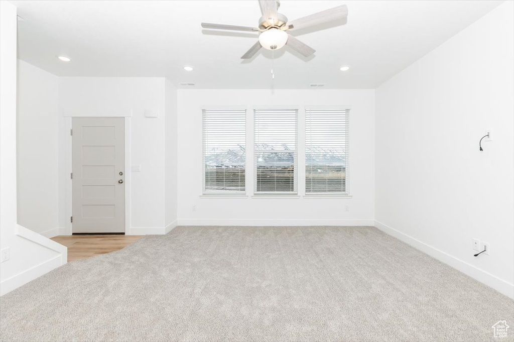 Spare room featuring recessed lighting, baseboards, light colored carpet, and ceiling fan