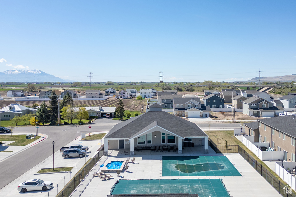 Community pool with a fenced backyard, a mountain view, a patio area, and a residential view
