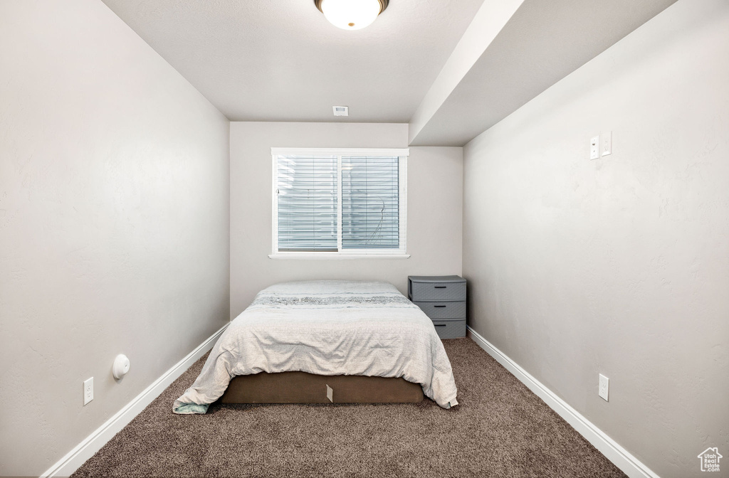 Bedroom with baseboards and carpet flooring