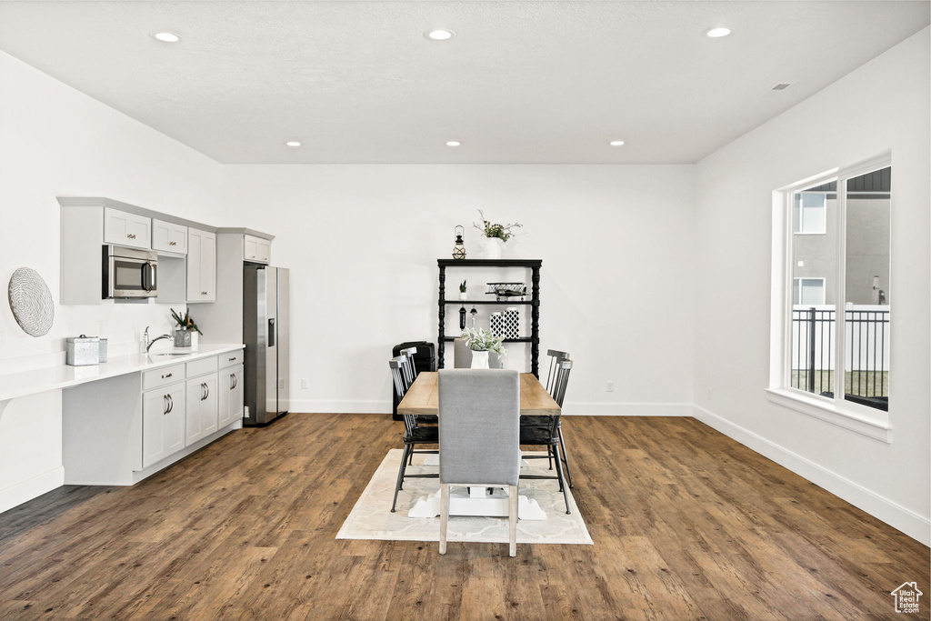 Dining area with recessed lighting, baseboards, and dark wood finished floors