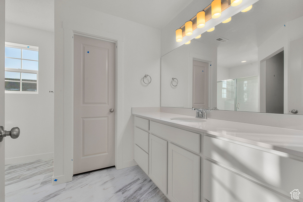 Full bathroom featuring visible vents, a shower stall, marble finish floor, and vanity