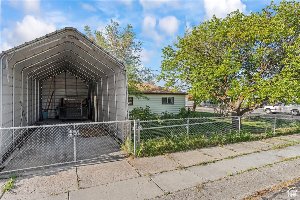 Exterior space featuring a carport and fence private yard