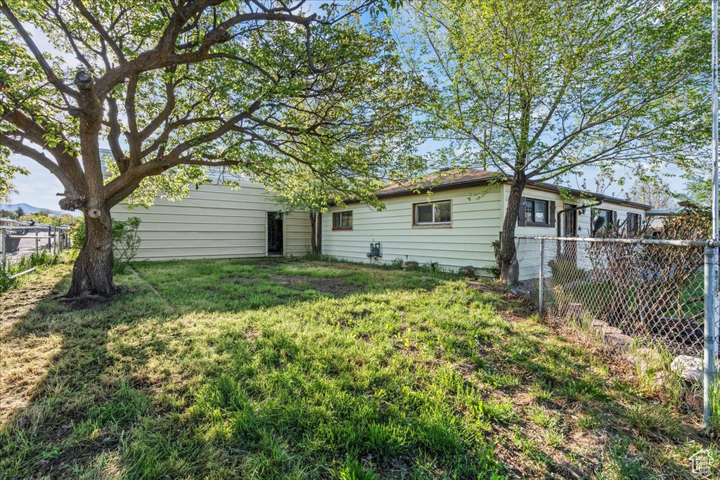 Exterior space with fence and a yard
