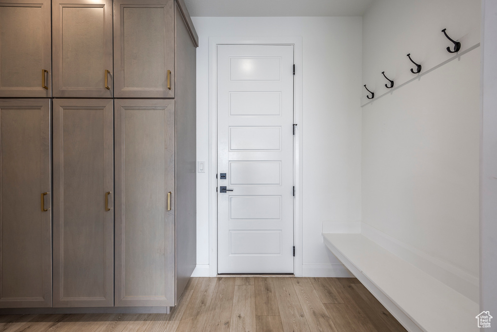 Mudroom with baseboards and light wood finished floors