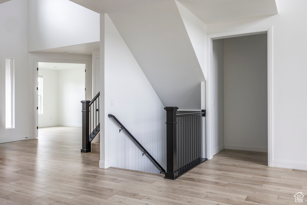 Stairs with baseboards and wood finished floors