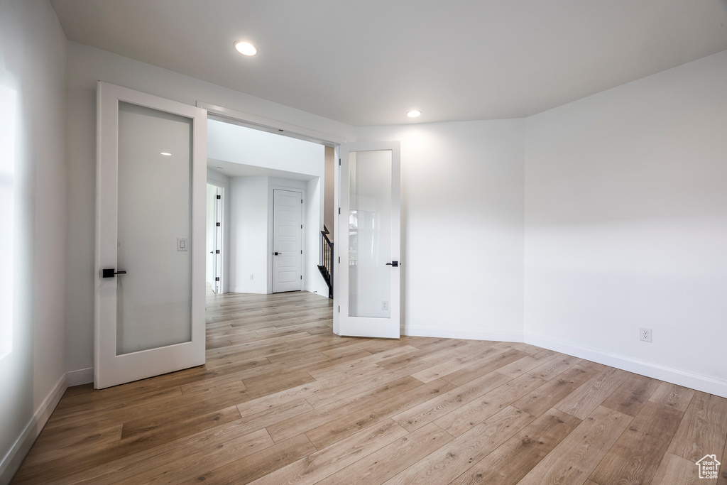 Spare room featuring recessed lighting, baseboards, and light wood-type flooring