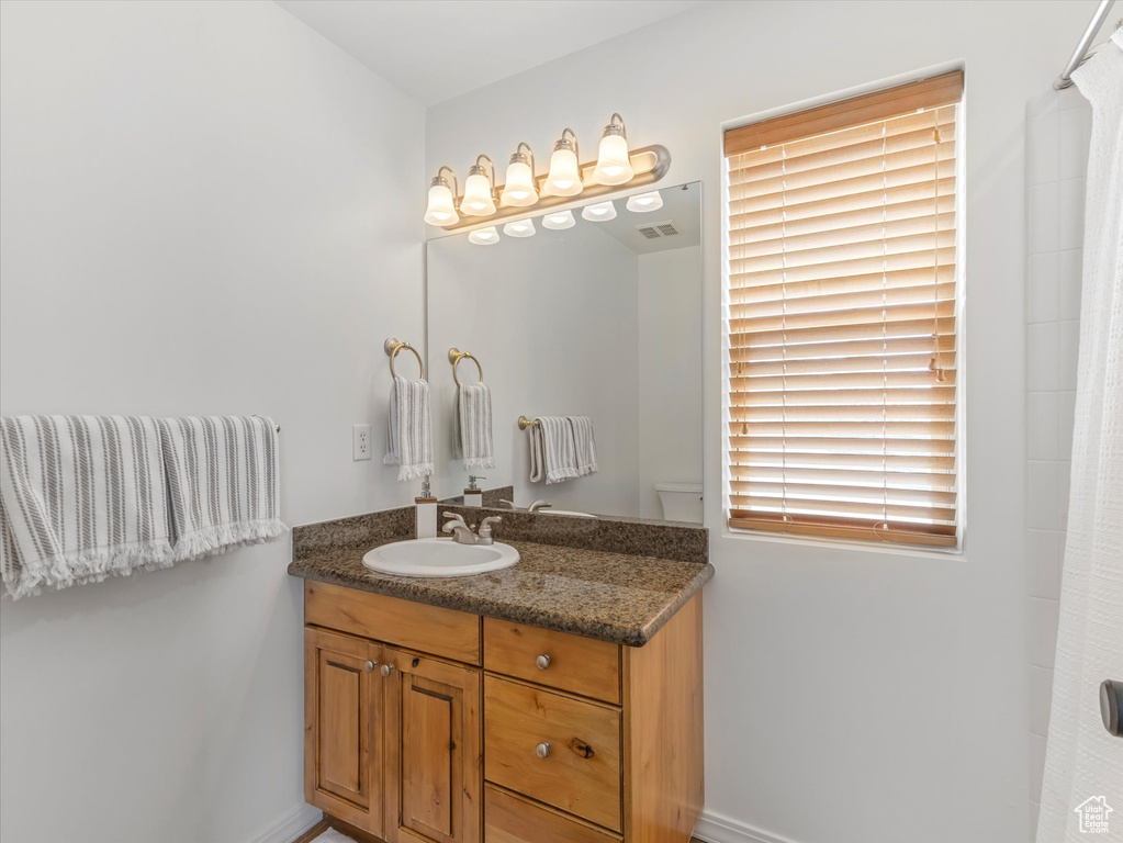 Full bath with visible vents and vanity