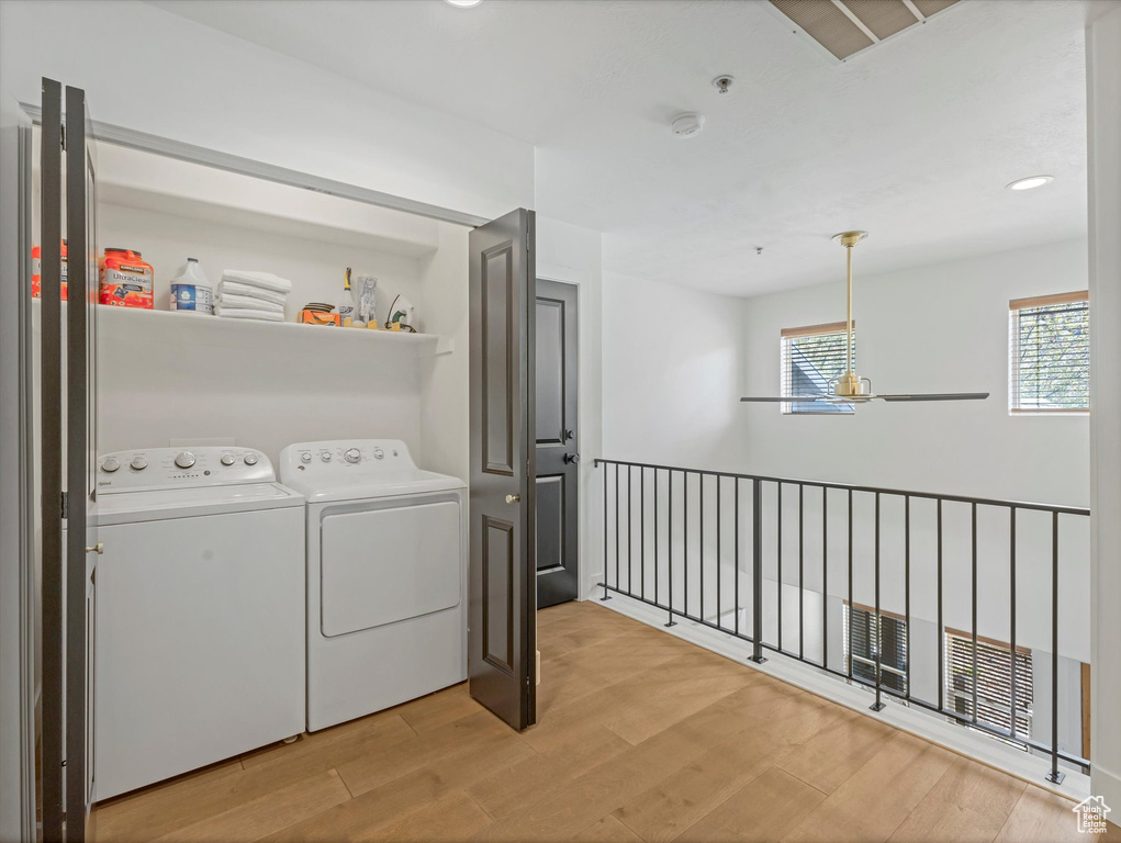 Laundry room featuring laundry area, recessed lighting, light wood-style flooring, and washer and dryer