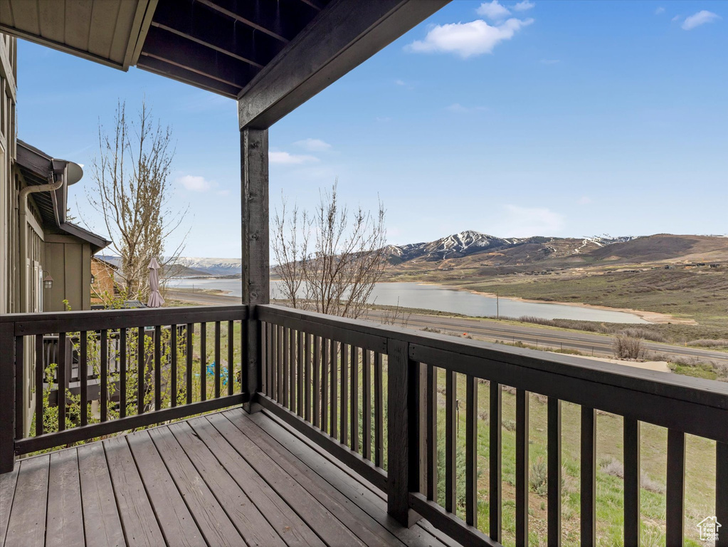 Deck with a water and mountain view