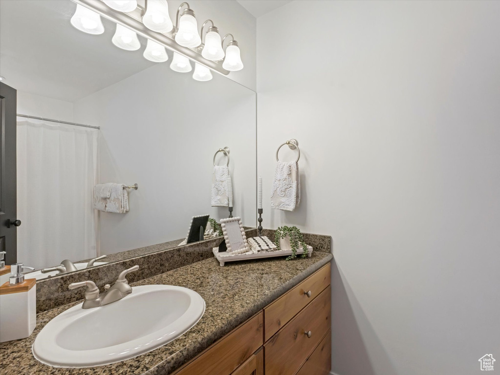Full bathroom featuring vanity and curtained shower