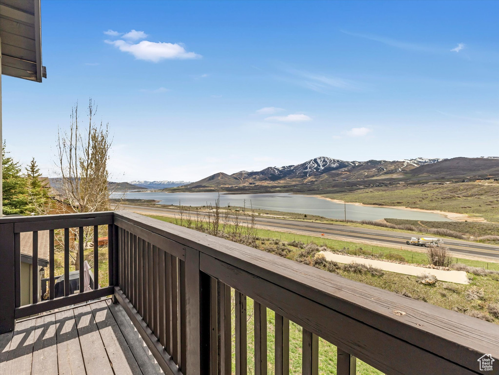 Deck with a water and mountain view