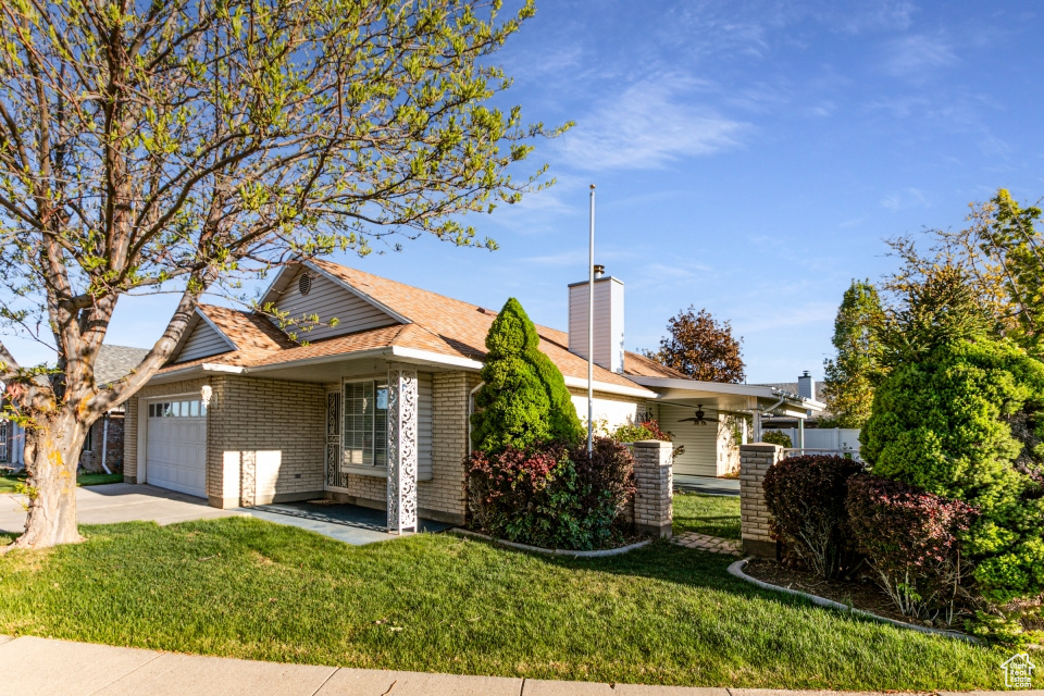 Ranch-style home with an attached garage, central AC, driveway, and a front lawn