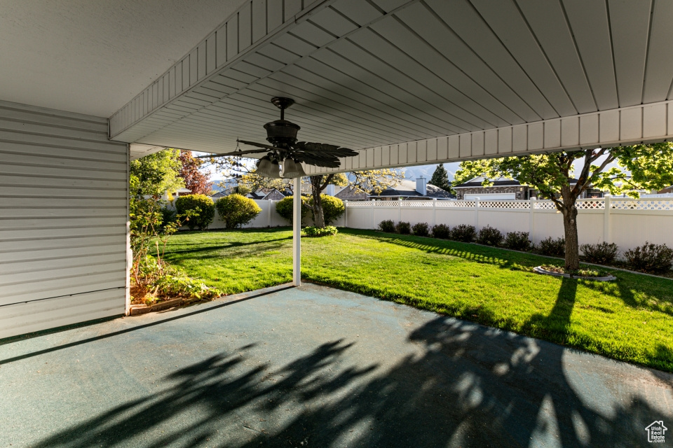 View of patio / terrace with a fenced backyard and a ceiling fan