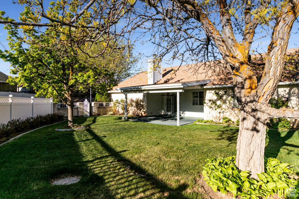 View of yard with a patio and fence