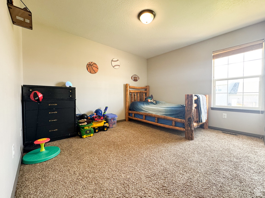 Carpeted bedroom featuring baseboards