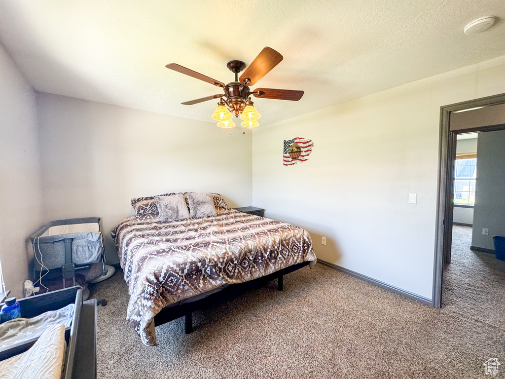 Bedroom featuring carpet flooring, a ceiling fan, and baseboards