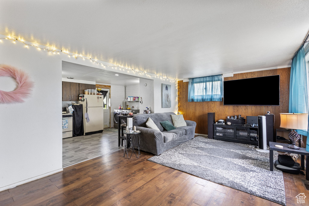 Living room with wood finished floors and wooden walls