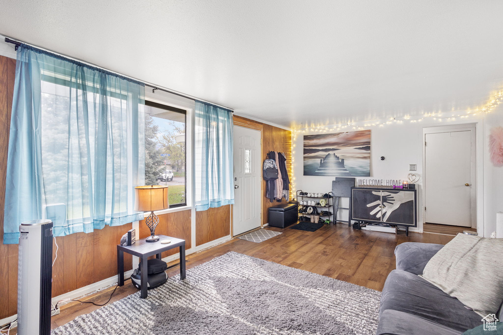 Living room with wood finished floors and radiator heating unit