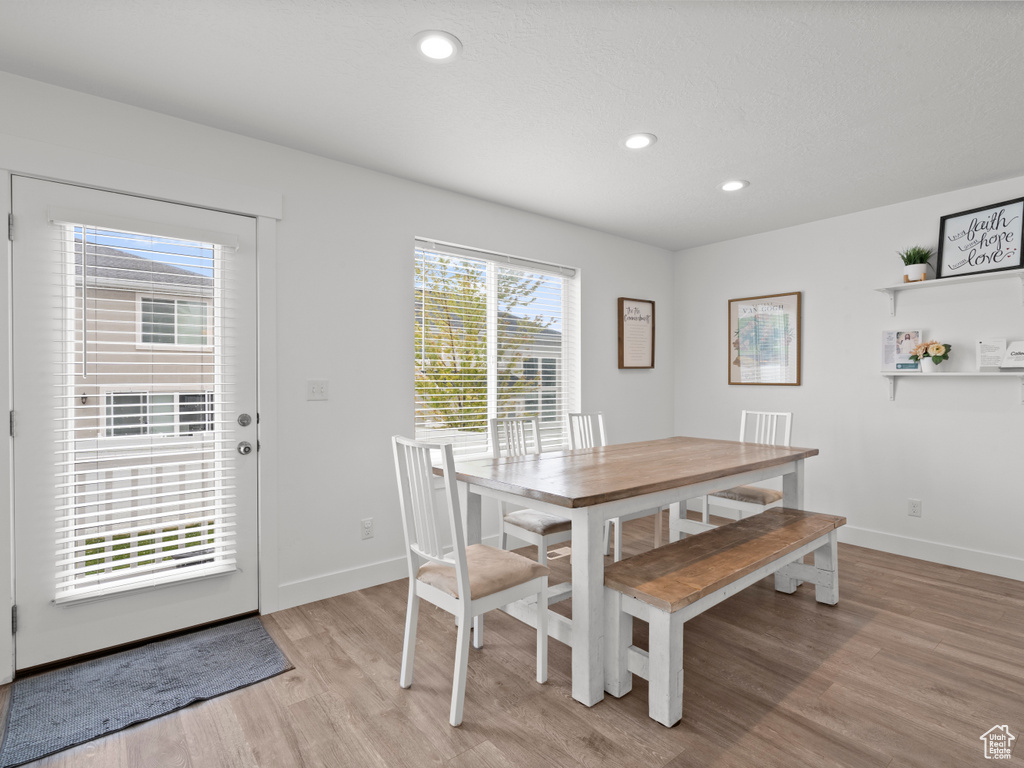 Dining space with recessed lighting, baseboards, and light wood finished floors