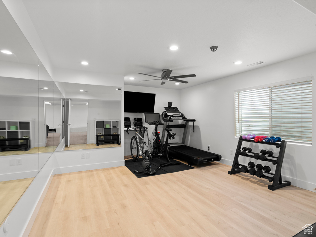 Exercise room with a ceiling fan, recessed lighting, wood finished floors, and visible vents
