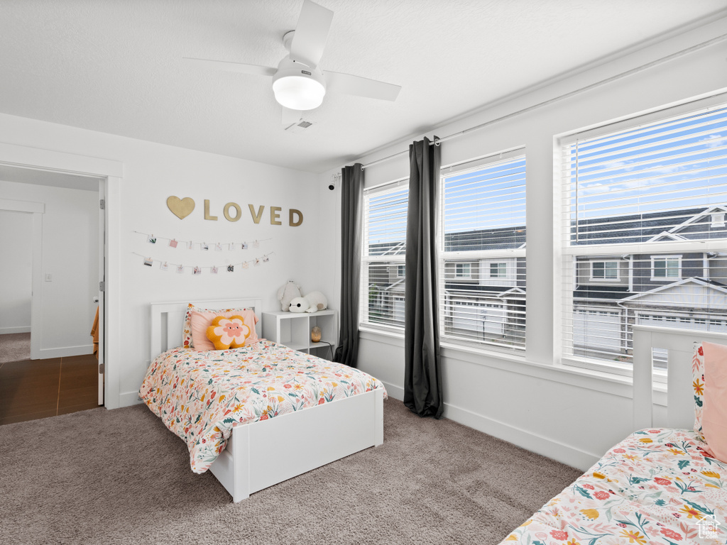 Bedroom featuring carpet flooring, a ceiling fan, baseboards, and visible vents
