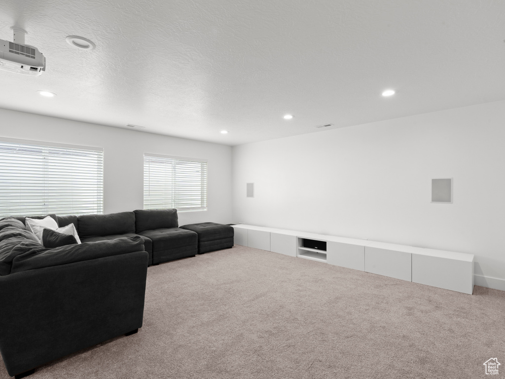 Living room with recessed lighting and carpet