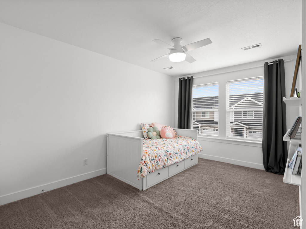 Bedroom with carpet floors, baseboards, and visible vents