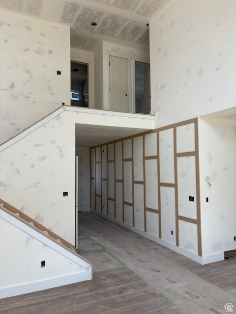 Stairway with baseboards and wood finished floors