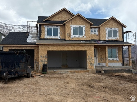 Unfinished property featuring a garage and central AC unit