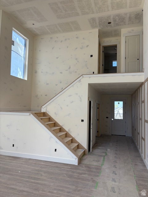 Stairs featuring wood finished floors