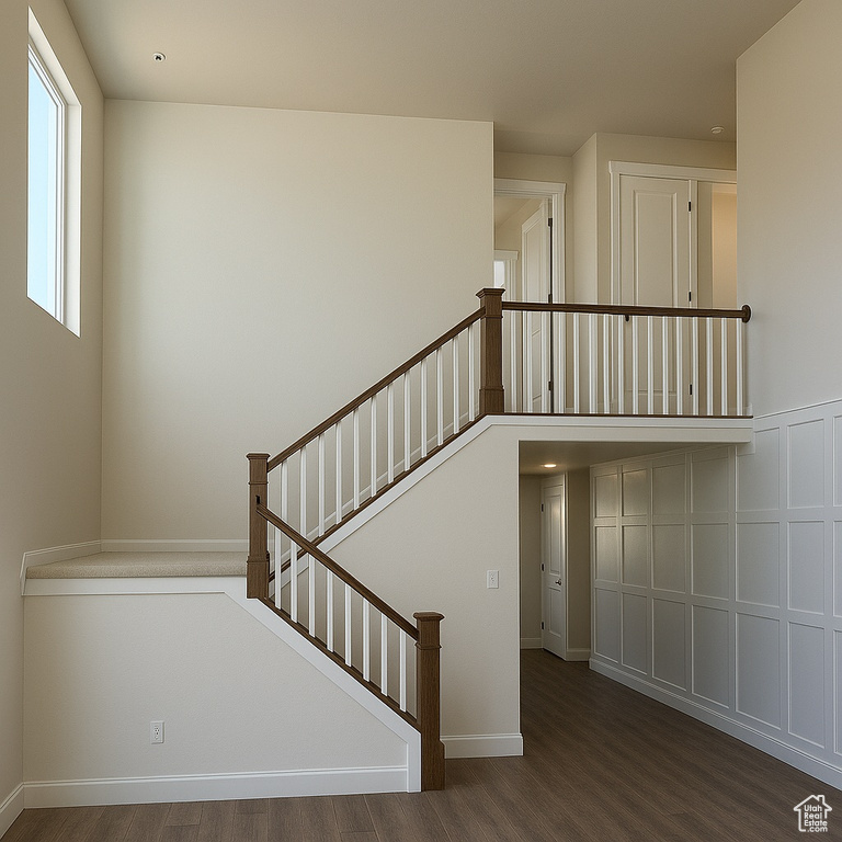 Staircase featuring wood finished floors and baseboards