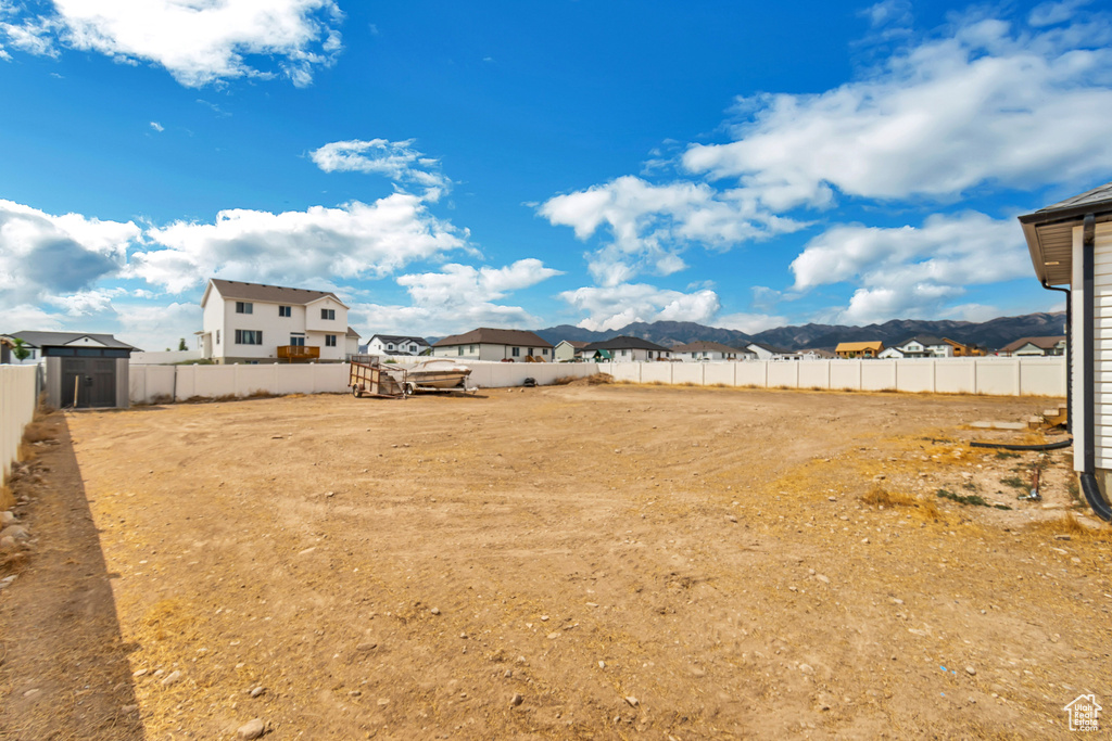 View of yard with a mountain view and a fenced backyard