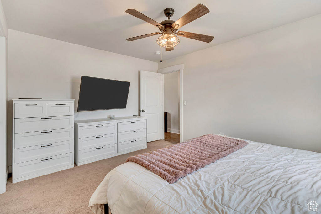 Bedroom featuring light carpet and a ceiling fan