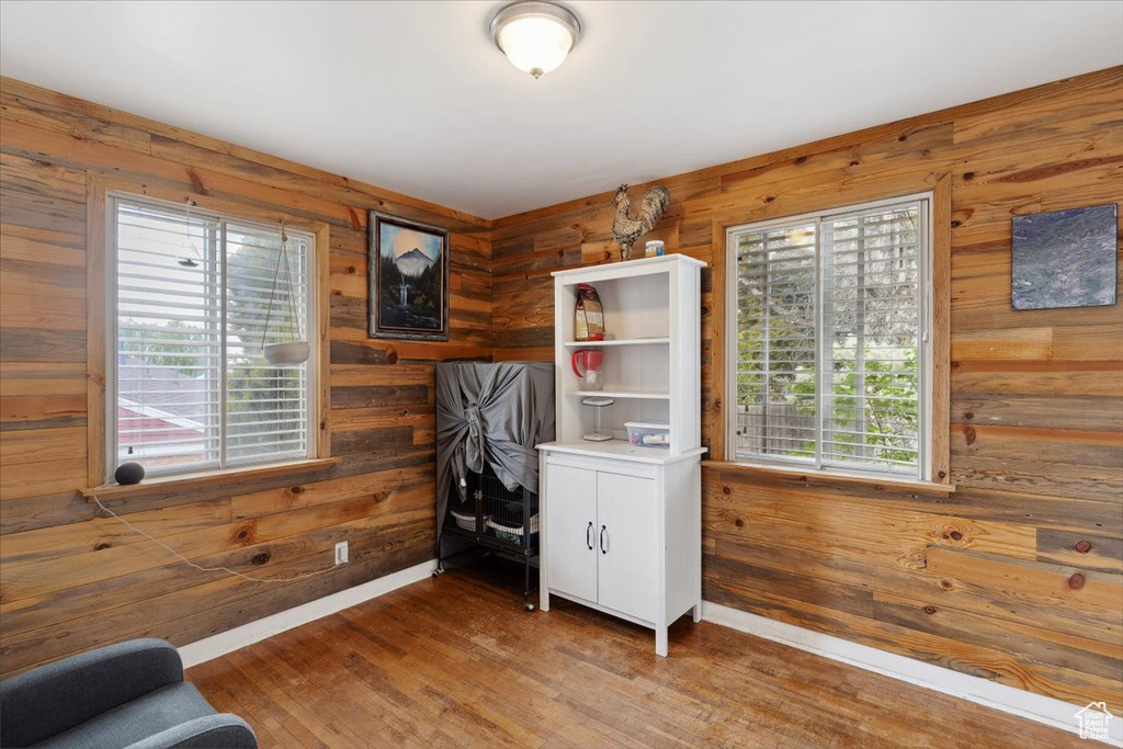 Office area featuring wood walls, wood finished floors, and a wealth of natural light