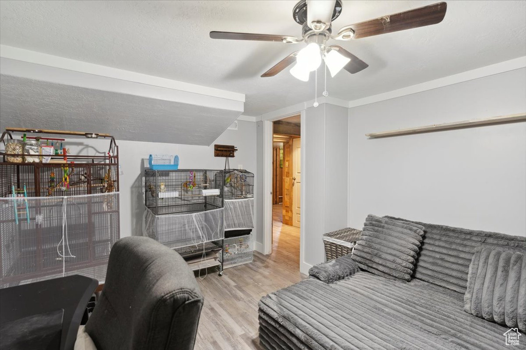 Interior space with ceiling fan and wood finished floors