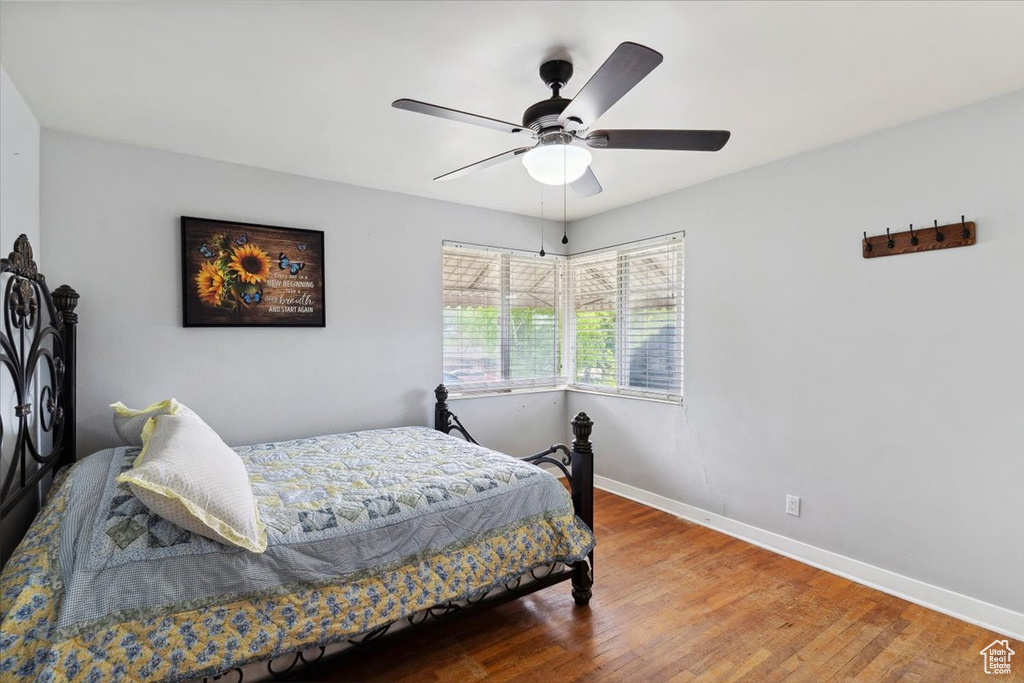 Bedroom with baseboards, ceiling fan, and wood finished floors