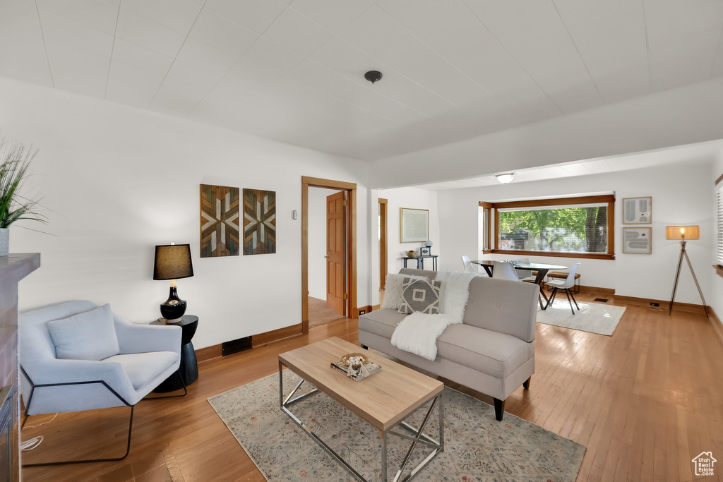 Living area featuring baseboards and light wood-type flooring