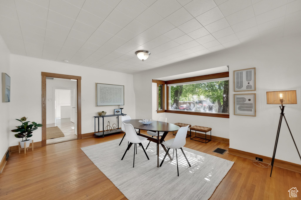 Dining space featuring baseboards, visible vents, and light wood-type flooring