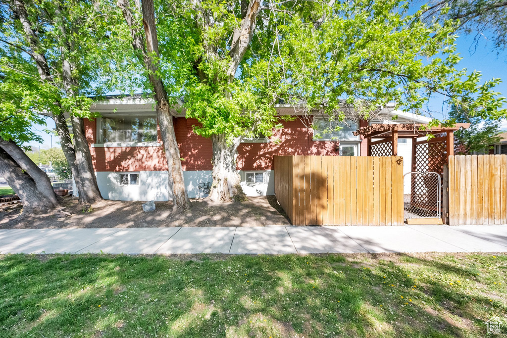 View of front facade with brick siding and fence