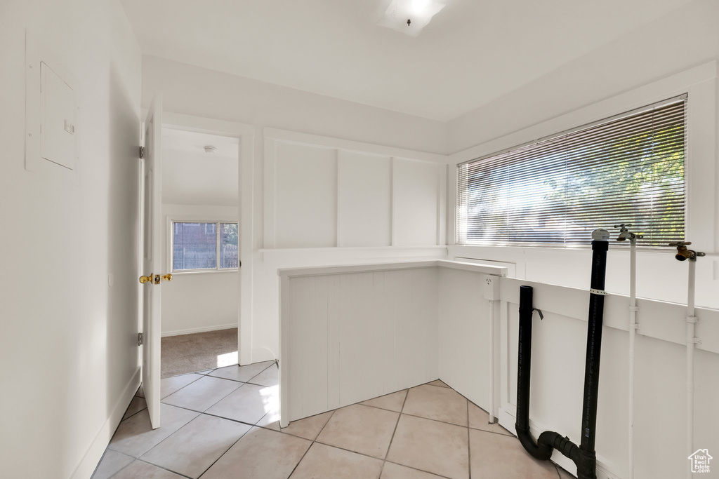 Interior space featuring light countertops, light tile patterned floors, and a healthy amount of sunlight