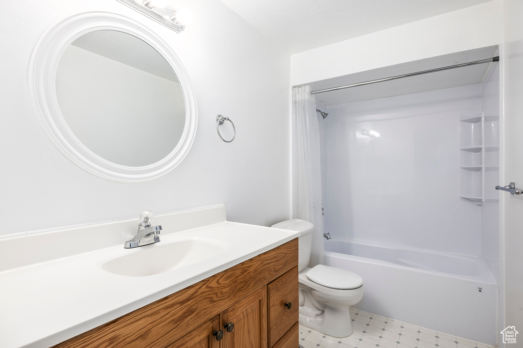 Bathroom featuring vanity, tub / shower combination, and toilet
