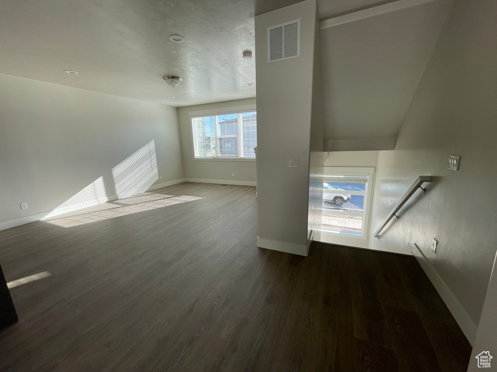 Unfurnished living room with baseboards and wood finished floors