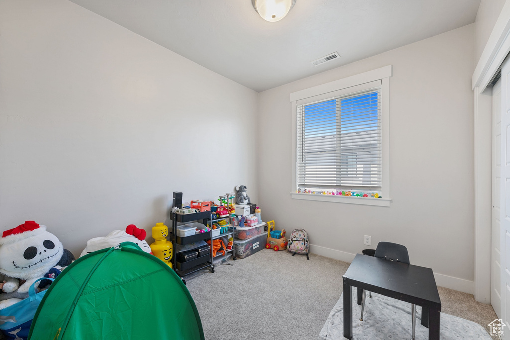 Recreation room with carpet floors, baseboards, and visible vents