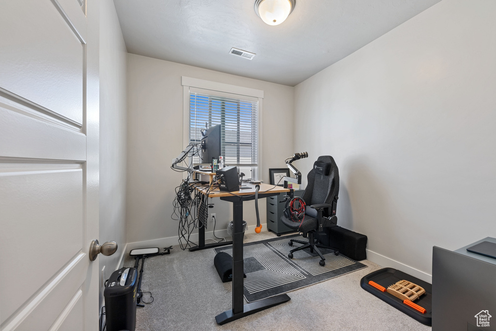 Workout area with visible vents, baseboards, and carpet floors